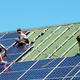 Workers install solar panels on a veterinary hospital in Littlestown, PA, 2010.